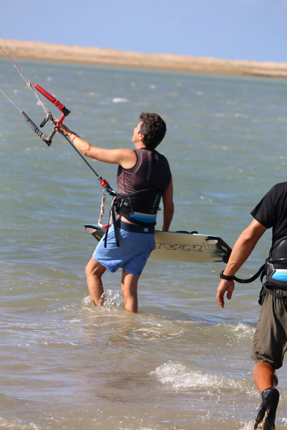 Isla Kite Center instructor teaching a beginner student in the shallow water of the Ilha do Guajirú lagoon